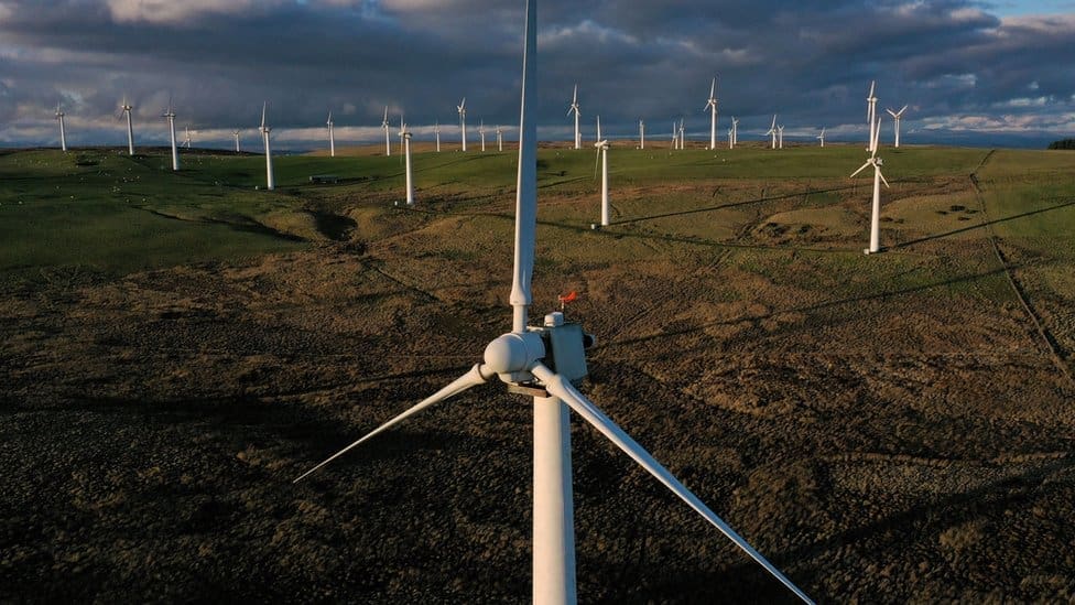 Wind turbines across open countryside generating renewable power for the UK energy supply